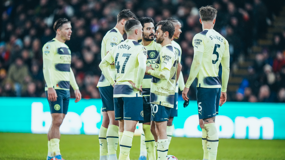 PLOTTING : Foden and co discuss a set-piece routine.