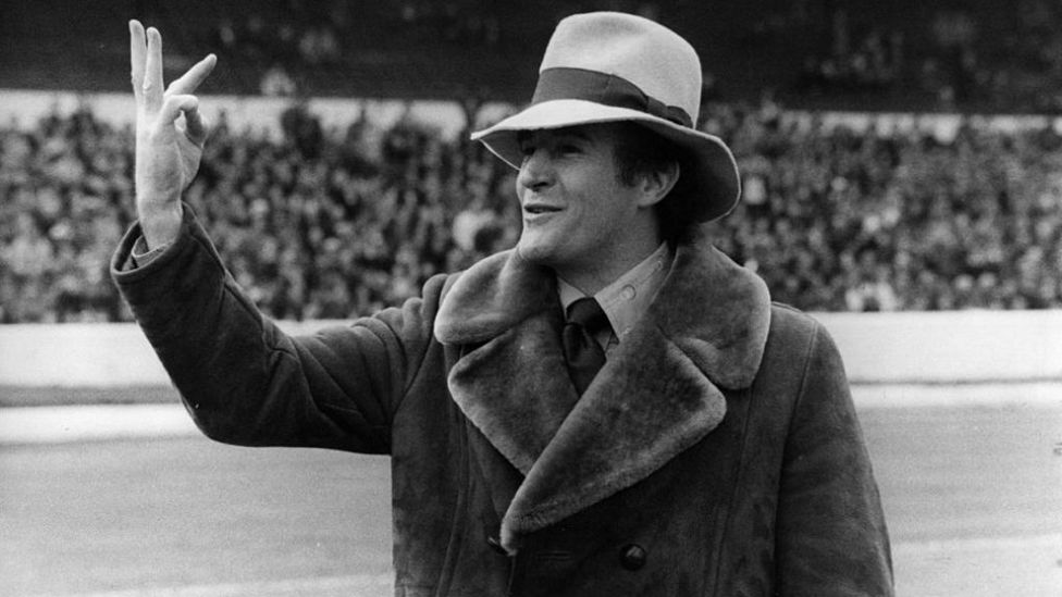 MR FLAMBOYANT: Wearing a fedora hat and sheepskin coat, Allison celebrates a victory during his time at Crystal Palace