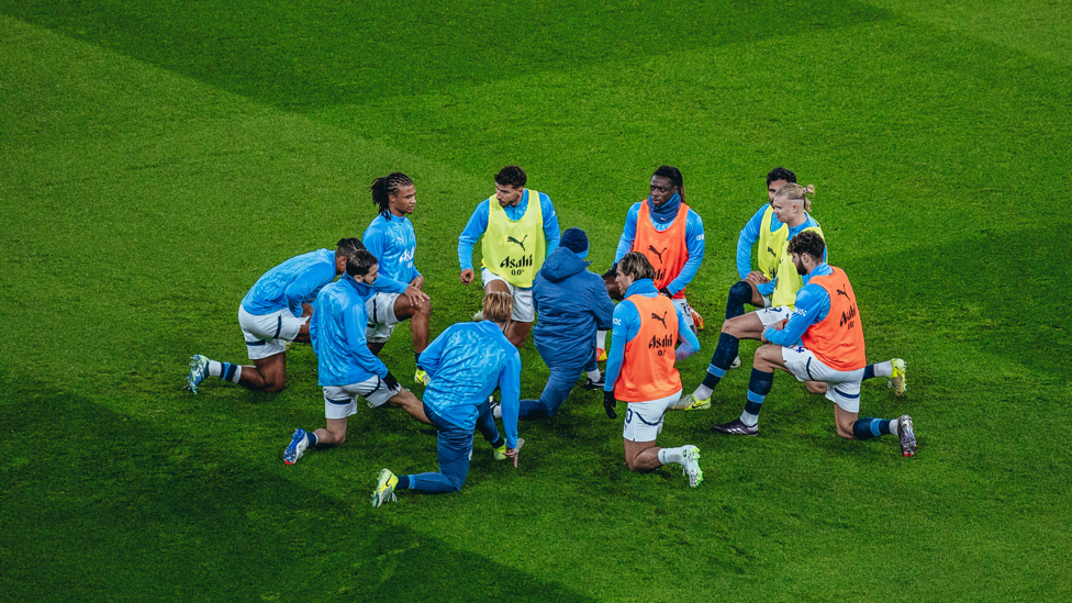 GET LOOSE : The players go through their pre-match stretches.