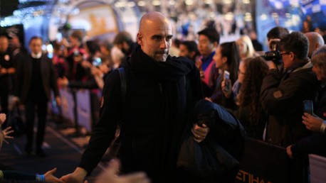 THE BOSS: Pep Guardiola checks in at the Etihad.