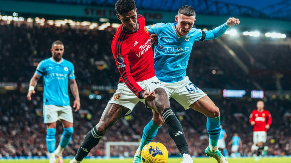 MANCUNIAN BATTLE : Foden and Rashford tussle for the ball.