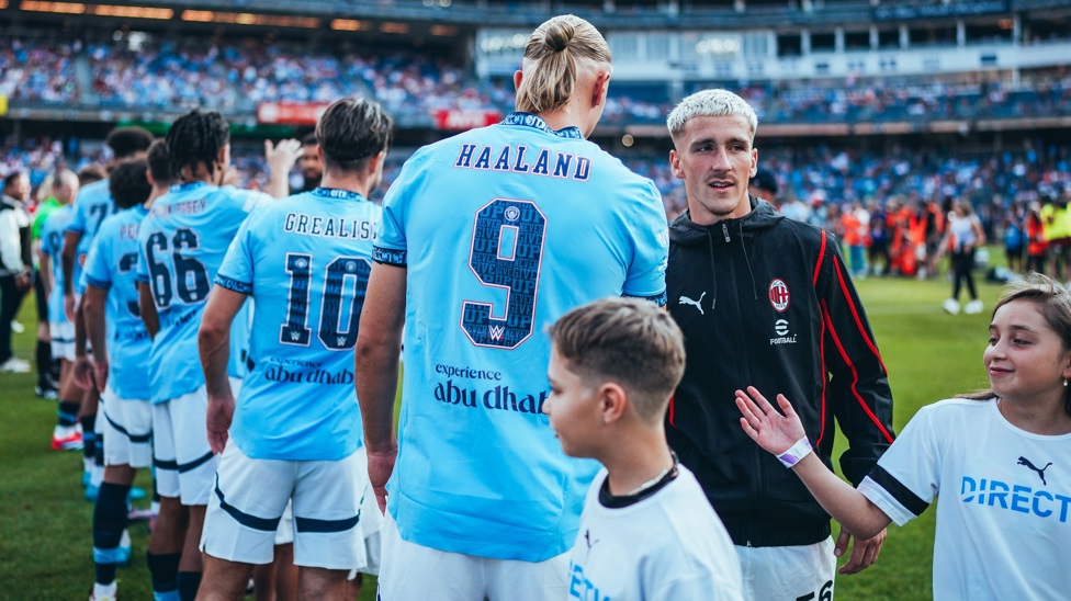 GREETINGS EXCHANGED : The teams take their pre-match handshake/fist-bump or hug