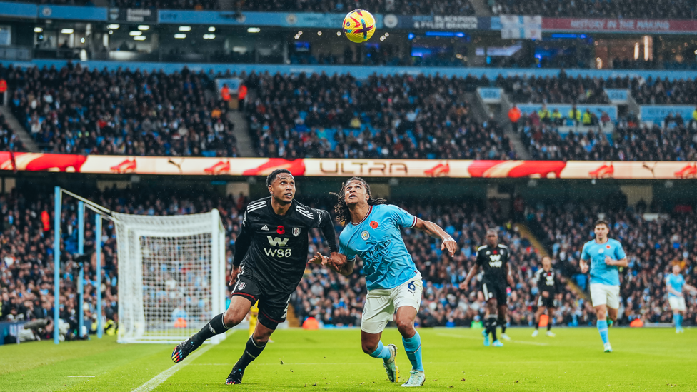 GAME ON : Ake contests a 50/50 ball.