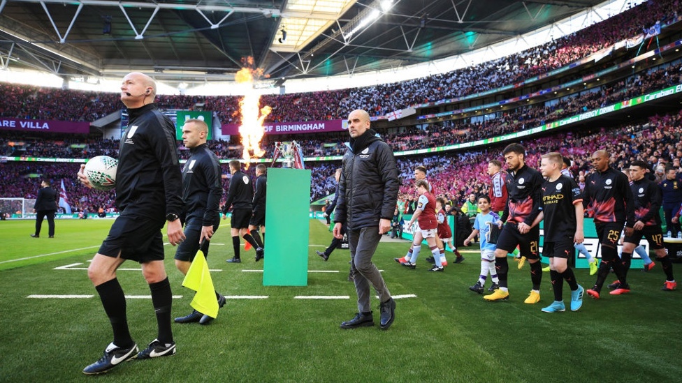 LEADER : Guardiola leads his players out onto the pitch.