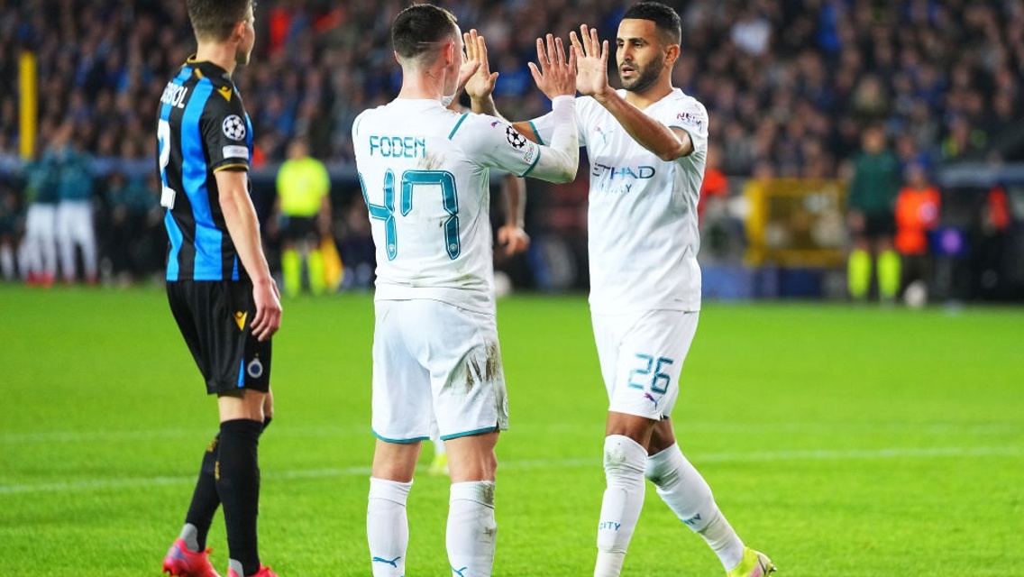 HIGH FIVES: Foden and Mahrez celebrate City's second of the evening.