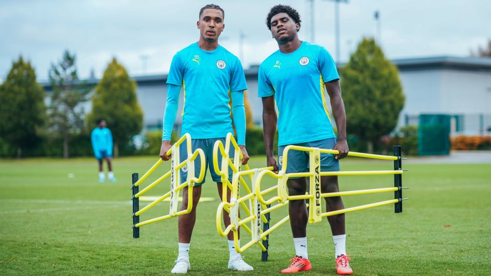 STRIKE A POSE : Lakyle Samuel and Jaden Heskey moving the equipment.