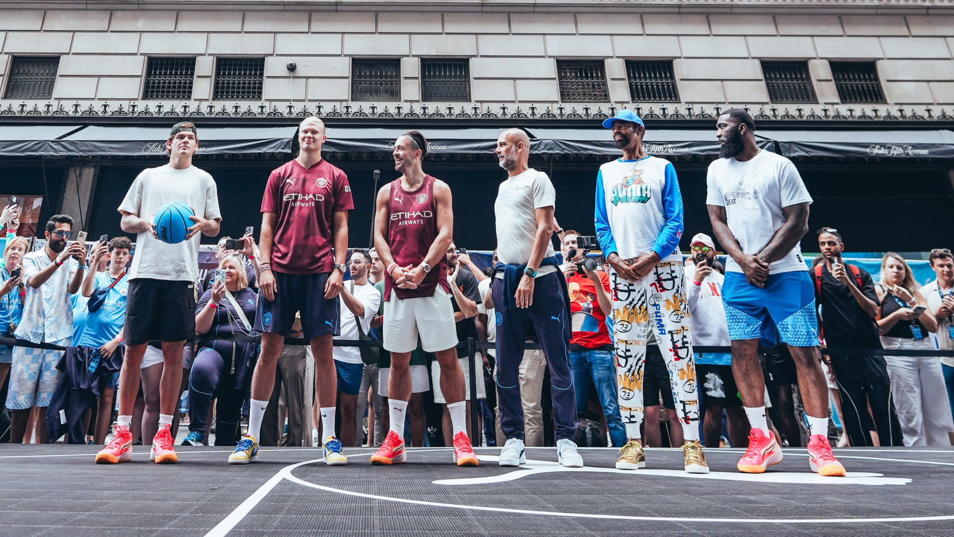 Man City star beam as he plays street basketball in New York in special outfit