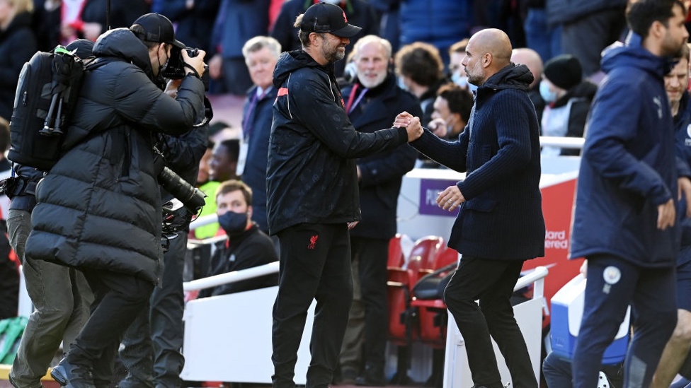 BOSSES : Klopp and Guardiola share a warm greeting on the touchline.