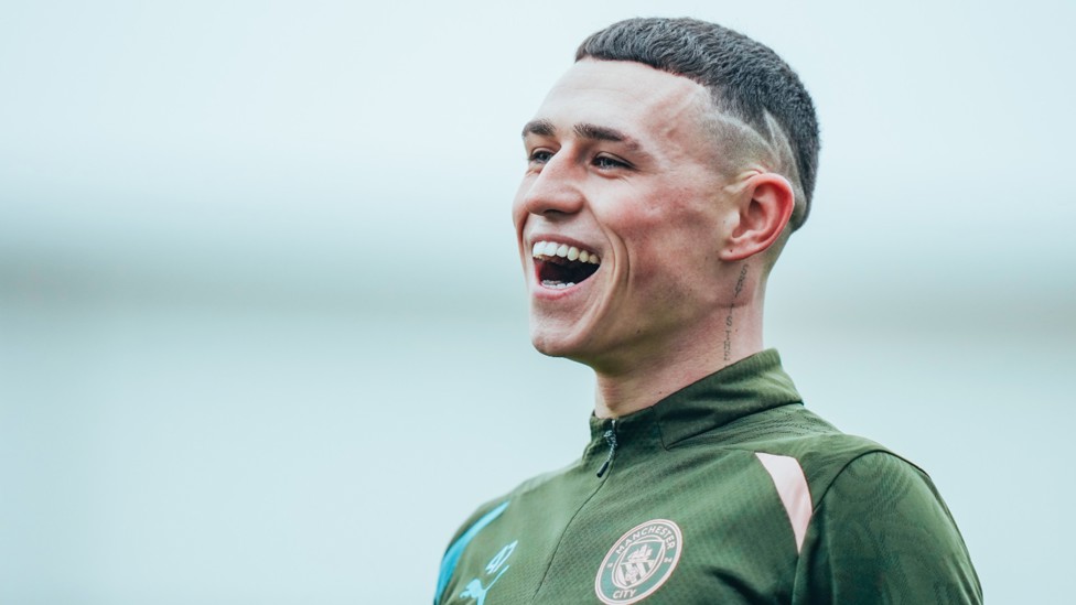 ALL SMILES: Phil Foden shares a light hearted moment during Monday's training session.