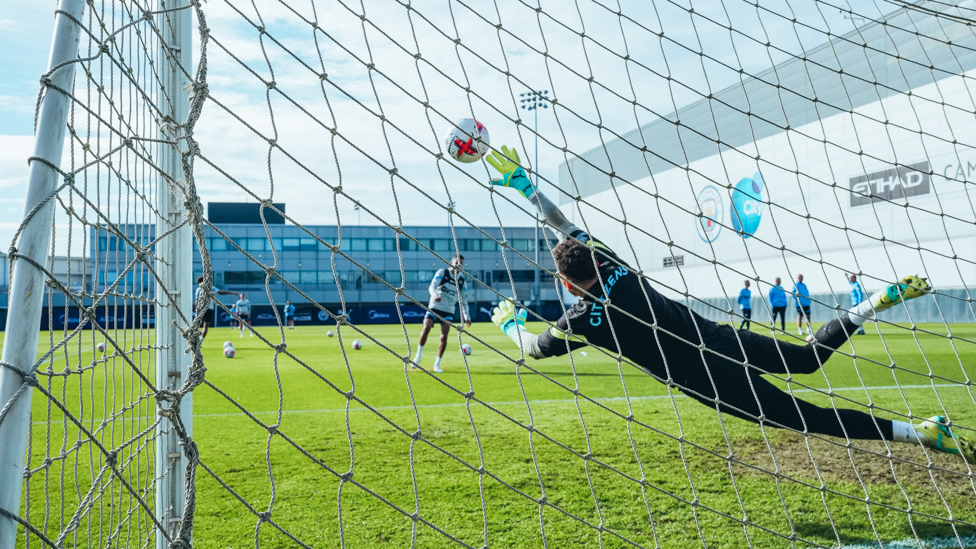 AT FULL STRETCH: Goalkeeper Ederson looks to keep out a Riyad Mahrez power shot.