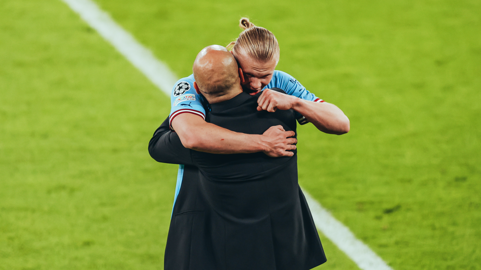 A WARM EMBRACE : Pep Guardiola and Erling Haaland take a moment to celebrate City's achievement.