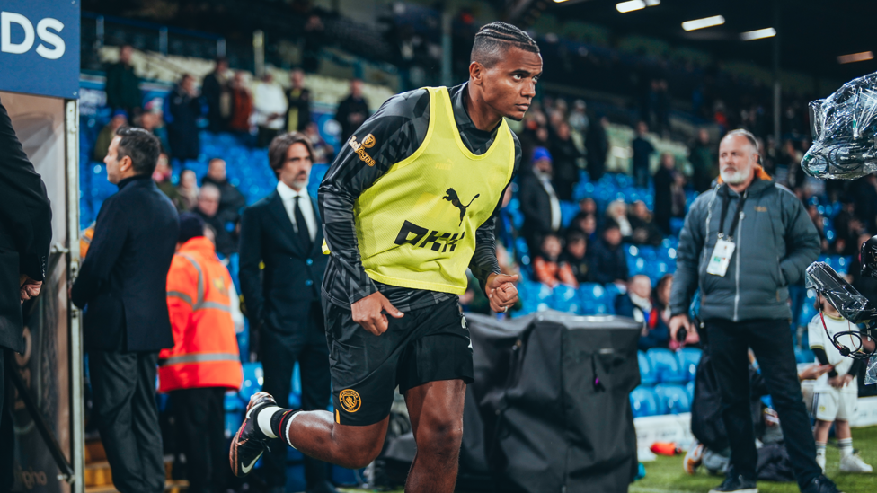 WARMUP : Akanji sprints out of the tunnel for the pre-match warm up. 