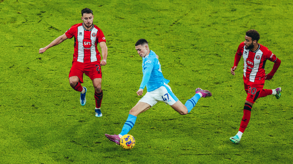 NEARLY THREE: Phil Foden is played through and rounds Wes Foderingham but is unable to find the back of the net