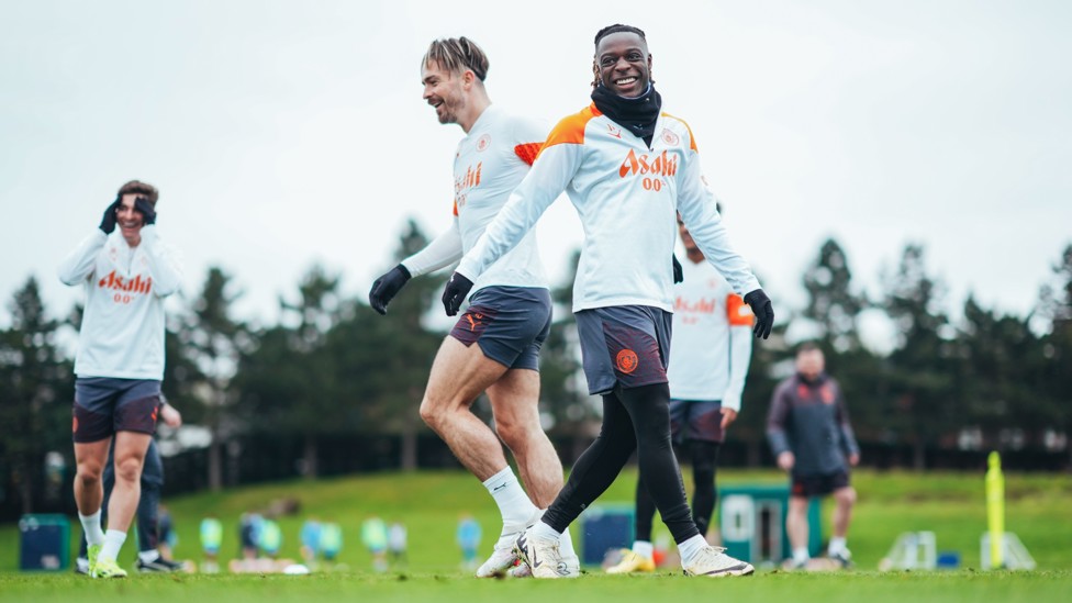 WING WONDERS : Jeremy Doku and Jack Grealish share a joke out on the training fields