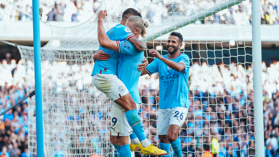 SCORER & PROVIDER : Haaland celebrates with Cancelo.