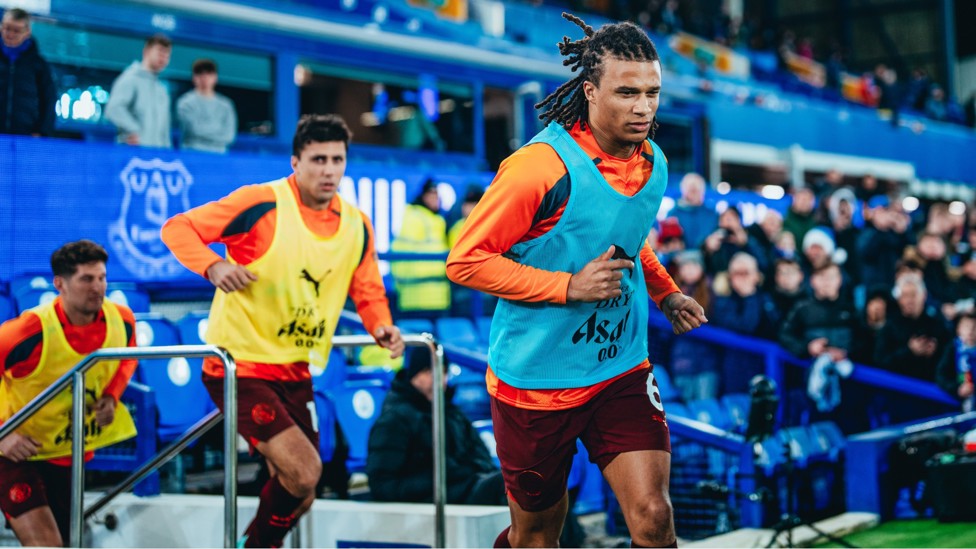 AKE AND CO : Emerge for the pre-match warm up.