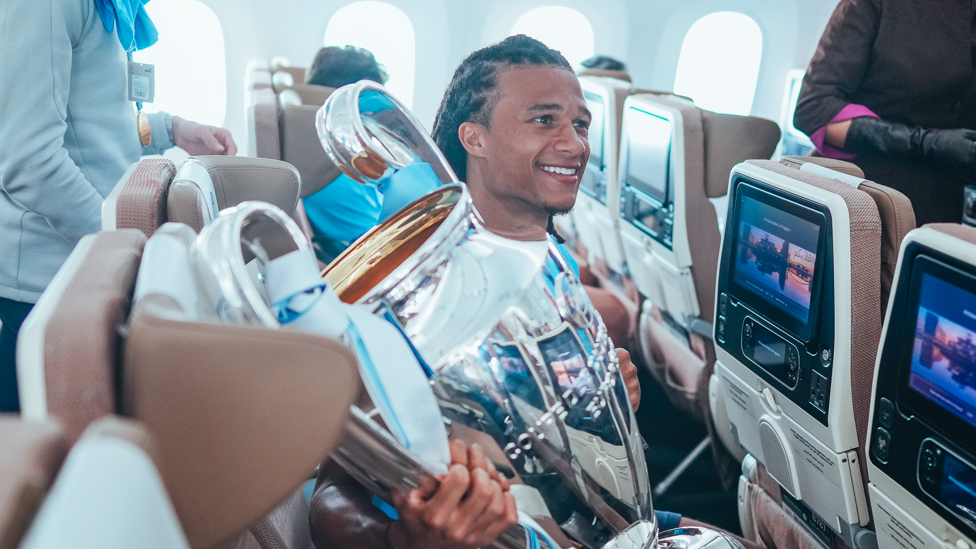 FLYING DUTCHMAN : Nathan Ake buckles the trophy in next to him on the flight.