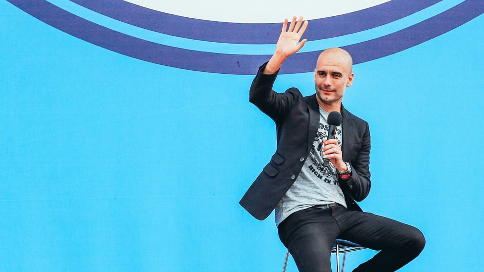 WARM WELCOME : Pep Guardiola waving at the City fans who came to welcome him to Manchester at the City Football Academy.