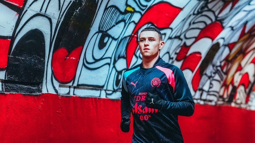 TUNNEL VISION : Phil Foden jogs down the famous tunnel to begin warming up.