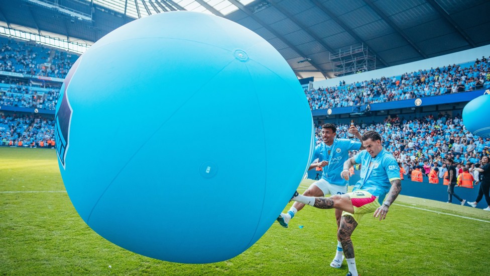 HAVE IT : Ederson and Matheus Nunes kick a large inflatable ball during the title celebrations