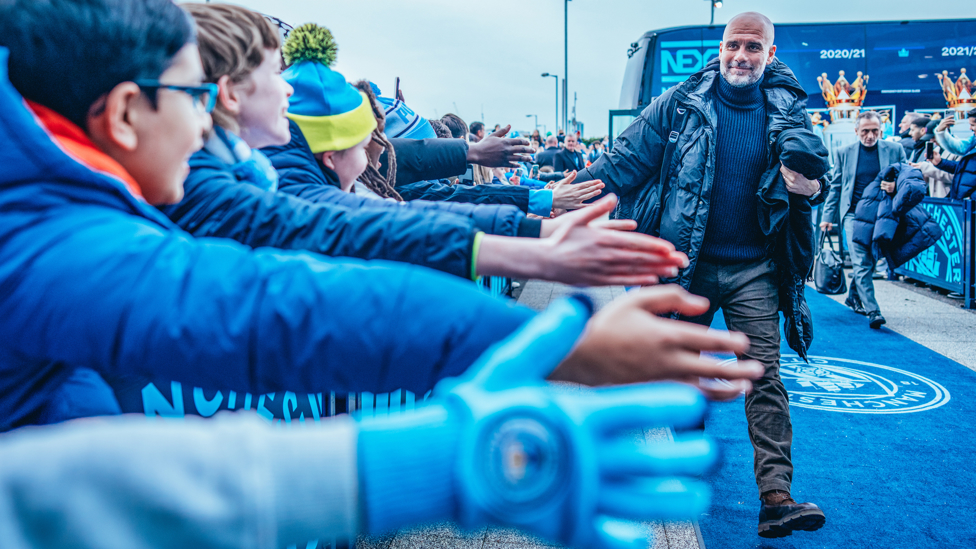 HAPPY PEP : Greeting the fans on his way into the stadium.