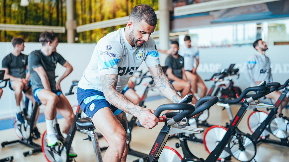 PEDALLING ALONG : Kyle Walker adjusts the setting on his bike. 