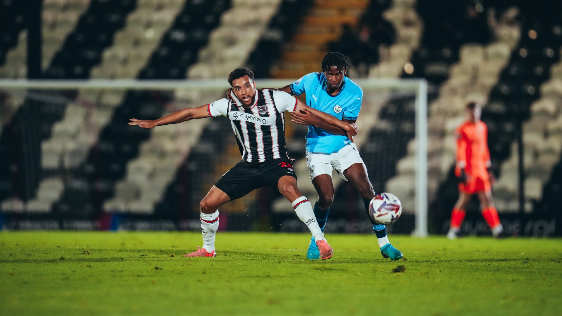 TOUGH CONTEST : Stephen Mfuni battles against Donovan Wilson for the ball.