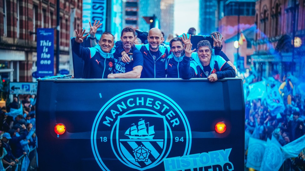 ON THE BUS : Guardiola and his coaching staff enjoy the parade