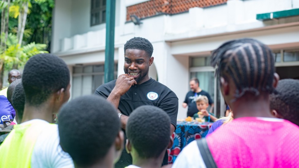 HERO : Micah Richards chats to youngsters in Nigeria.