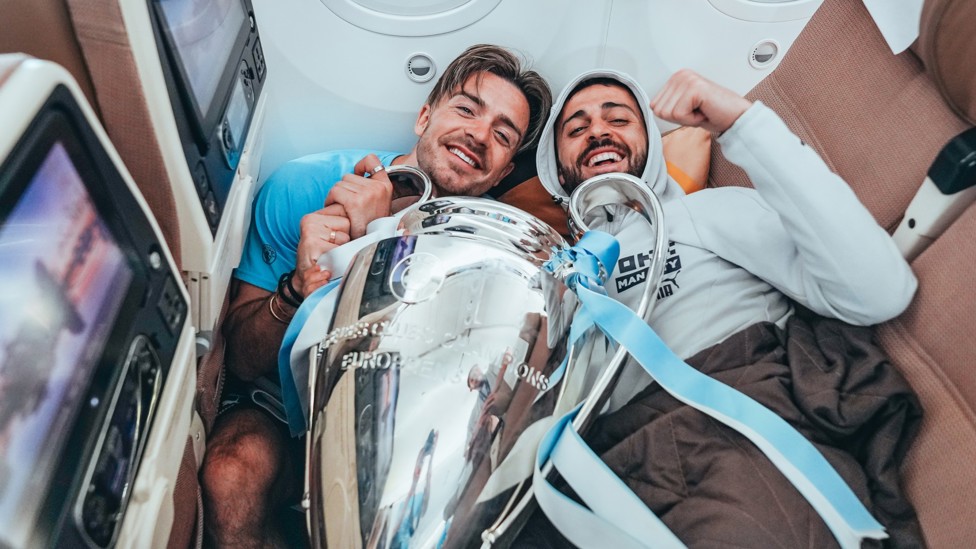 FLYING HIGH : Jack Grealish and Bernardo Silva have fun on the plane ride home from Istanbul to Manchester