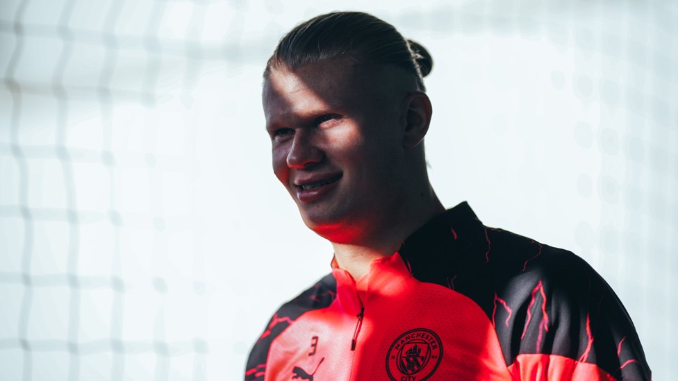 SUNNY DISPOSITION : Erling Haaland all smiles as he steps out for training on a bright Manchester afternoon