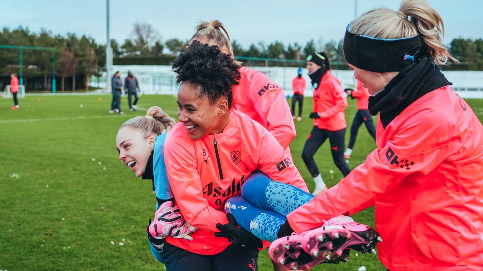 IN THE AIR : Ellie Roebuck is carried away by Demi Stokes and Alex Greenwood 