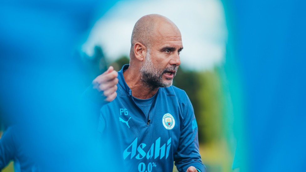 LEADER : Pep Guardiola talking to his players. 