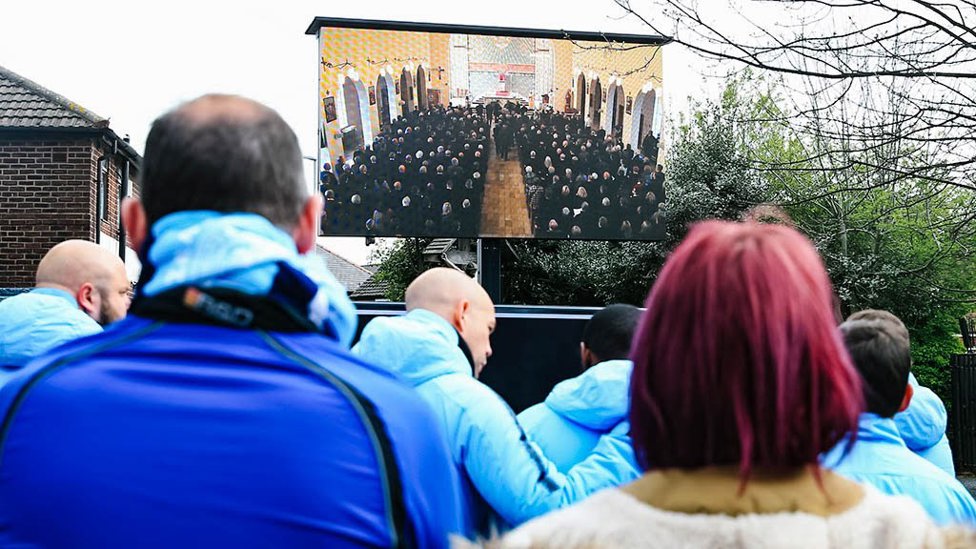 The service was streamed outside for fans.