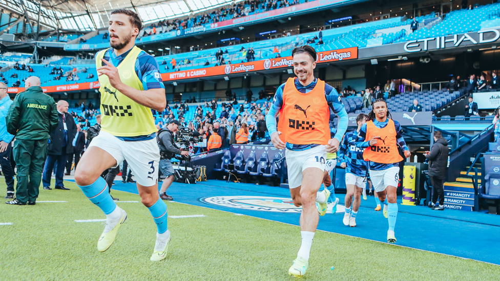 FINISHING TOUCHES : The players emerge for the pre-match warm up.