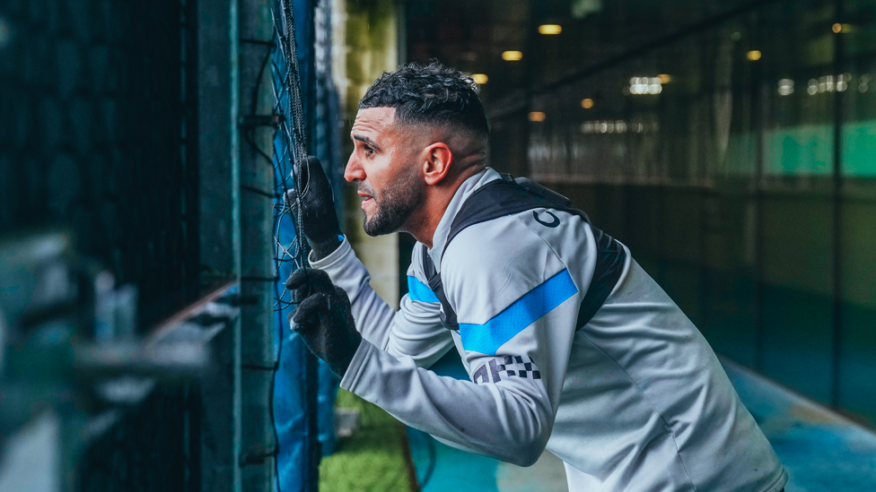 WATCHFUL WINGER  : Riyad Mahrez takes a peak at training 