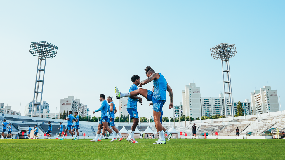 LIMBERING UP : The team take part in some active stretches at the start of training