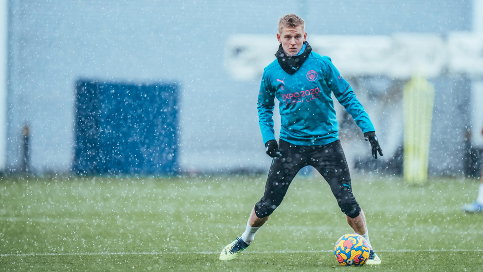 ON THE BALL : Oleksandr Zinchenko braves the elements