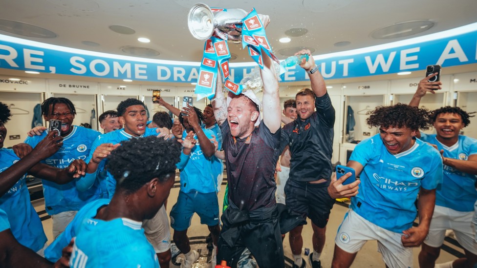 BOSSING IT : Ben Wilkinson celebrates with his players in the Etihad dressing room