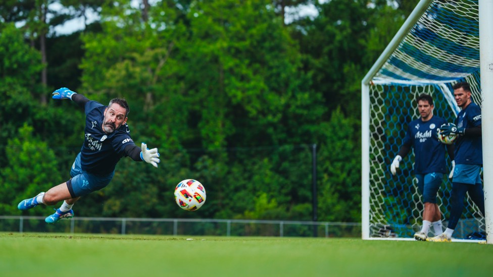 REFLEXES : Scott Carson gets down to make the save