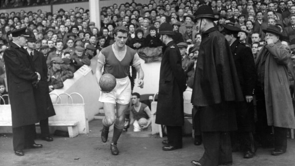 HAMMER TIME: Malcolm leads West Ham at Upton Park during his playing days