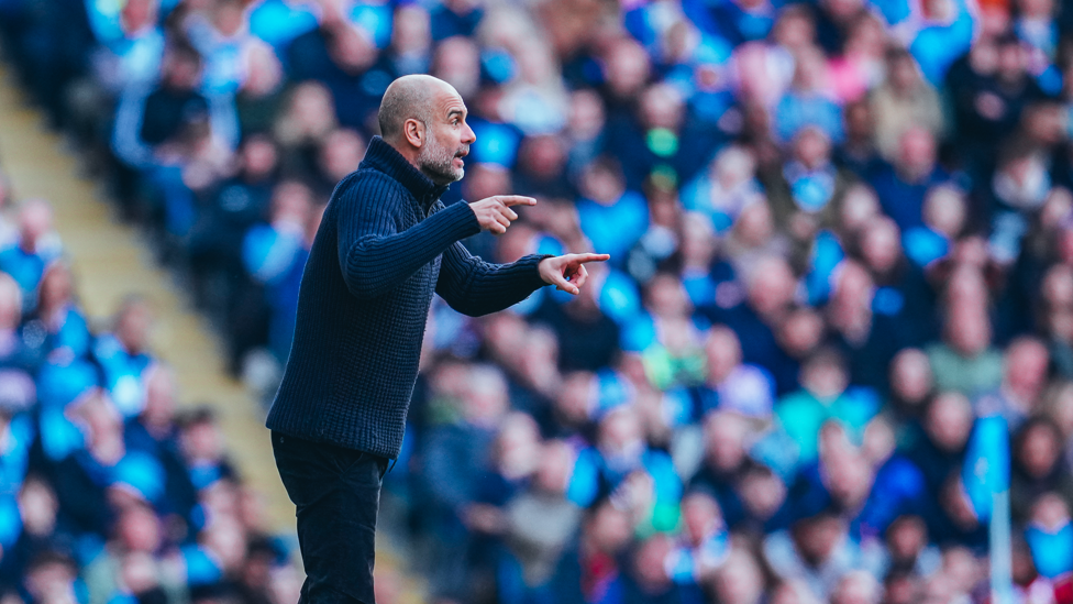 PULLING THE STRINGS : Pep shuffles his pack as he tries to see out the game. 