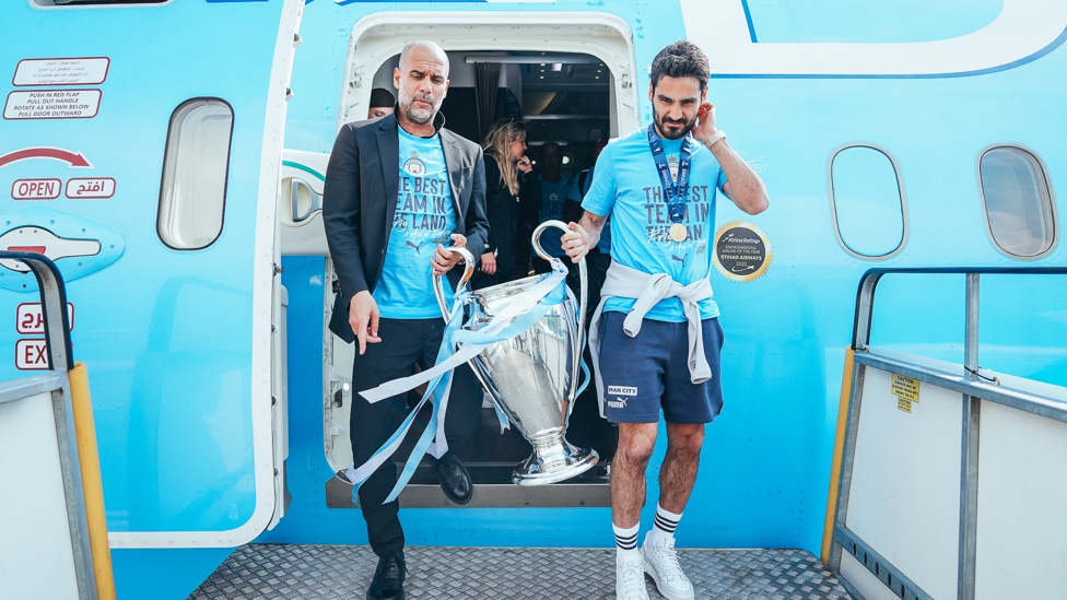 HOME SOIL : Pep and Gundogan bring the trophy off the plane